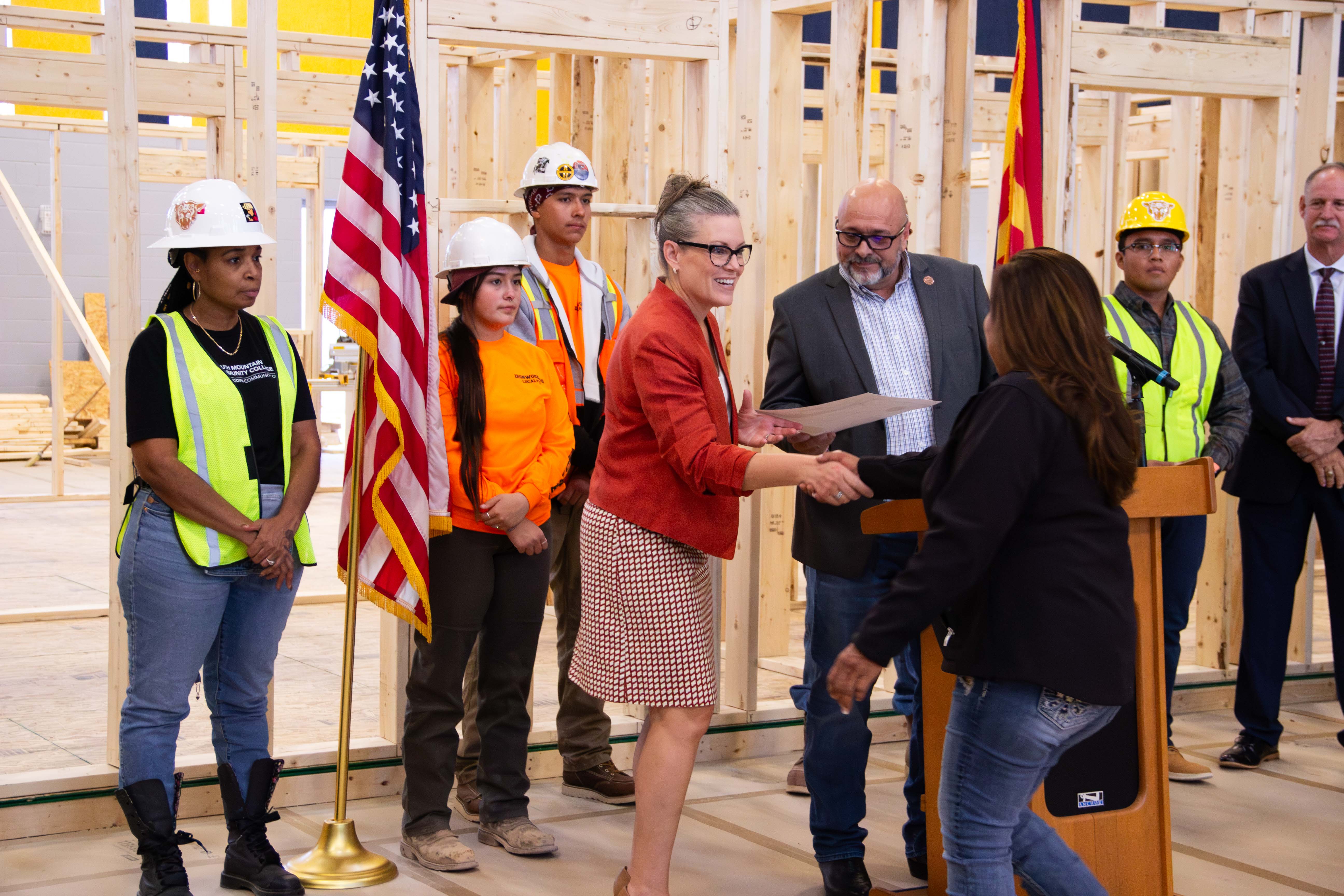 Governor Katie Hobbs announcing the BuilditAZ apprenticeship initiative grant with a variety of construction workers backing her.