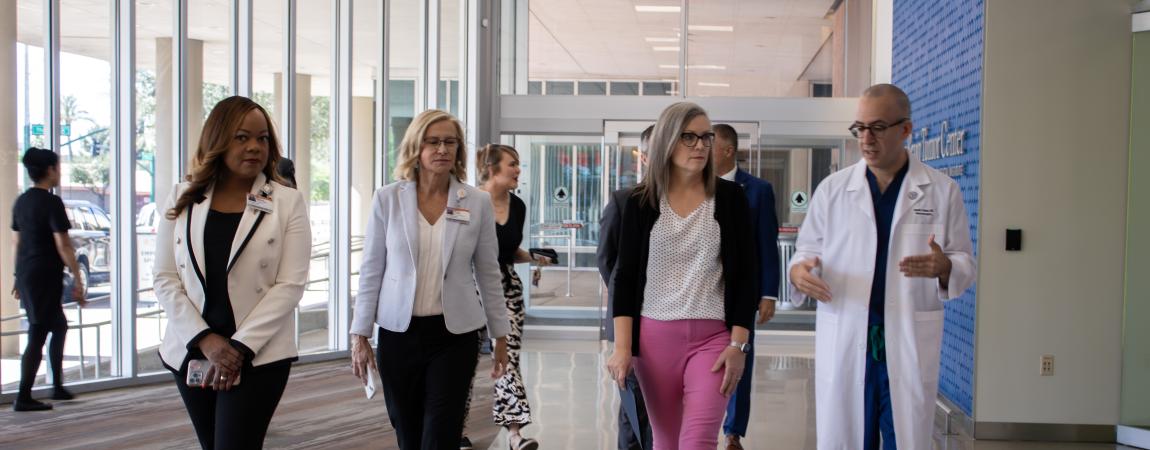 Governor Katie Hobbs walking with health leaders through Dignity Health's new brain tumor center.