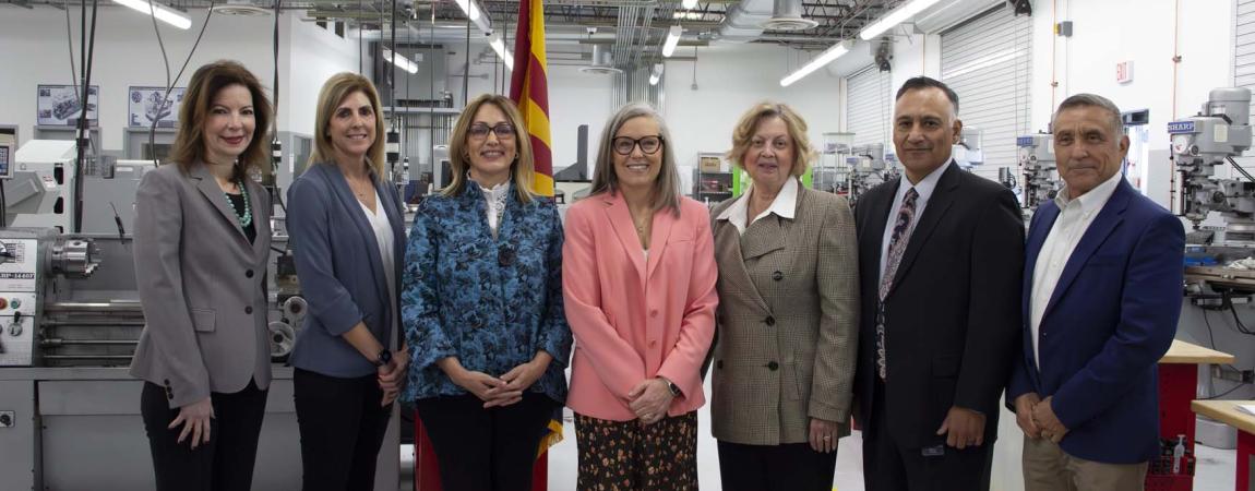 Governor Hobbs surrounded by people in a fabrication facility