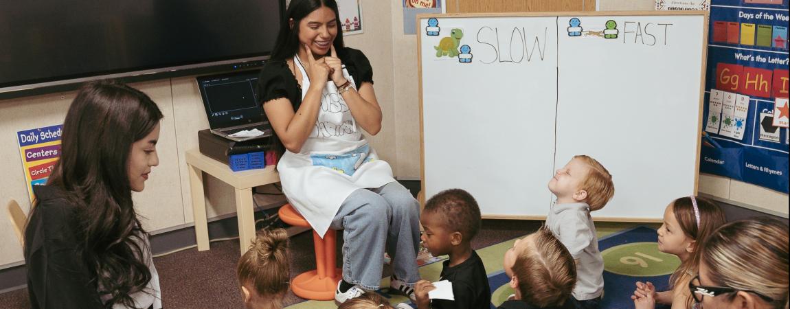 Teachers teaching a small class of young children.