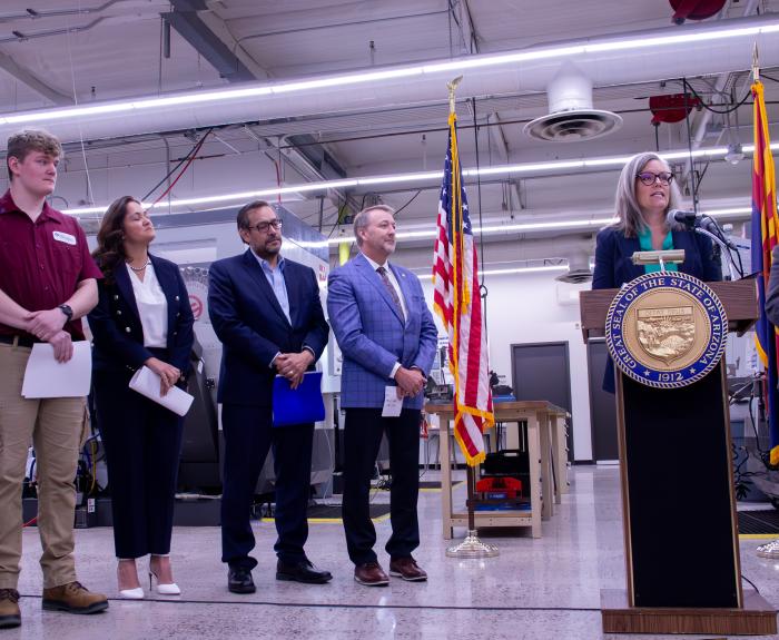 Governor Katie Hobbs speaking in fabrication facility alongside select employees.