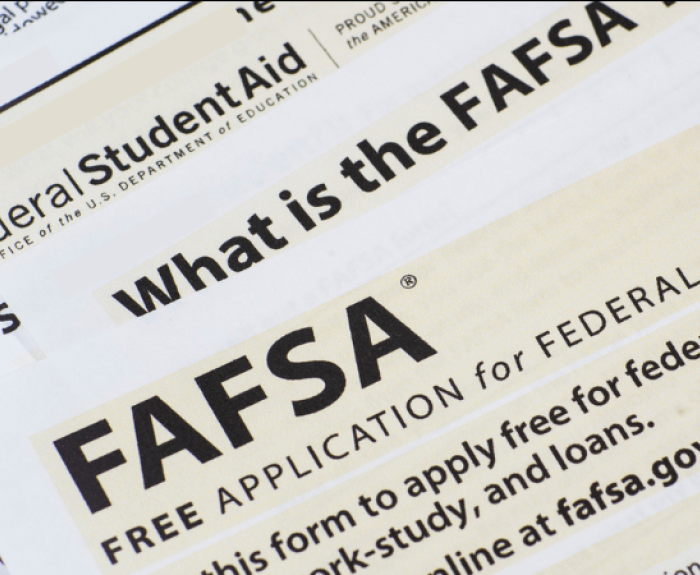 A portrait of Governor Katie Hobbs with a FAFSA paperwork graphic.