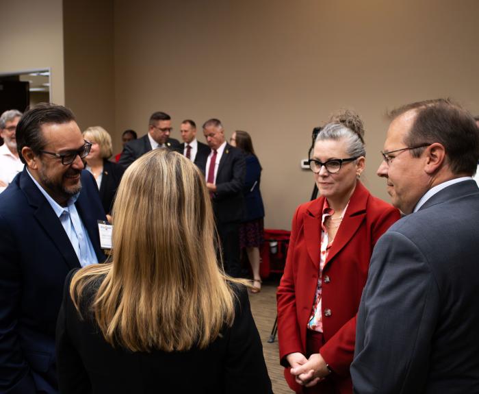 Governor Katie Hobbs in a group conversation with 3 other people.