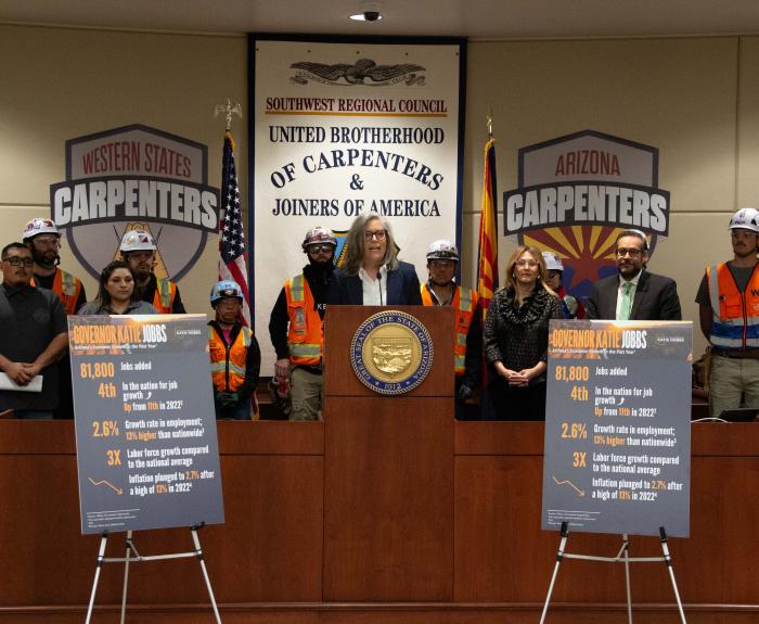Governor Katie Hobbs giving a speech at the United Brotherhood of Carpenters and Joiners of America.