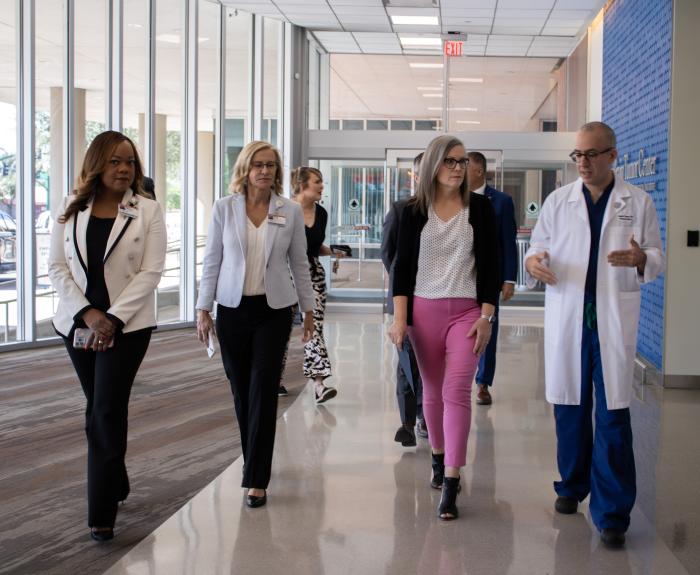 Governor Katie Hobbs walking with health leaders through Dignity Health's new brain tumor center.