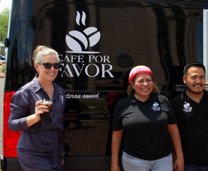 Governor Hobbs posing with a coffee with the coffee trucks business owners.