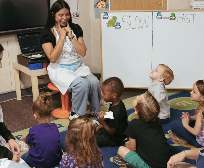 Teachers teaching a small class of young children.