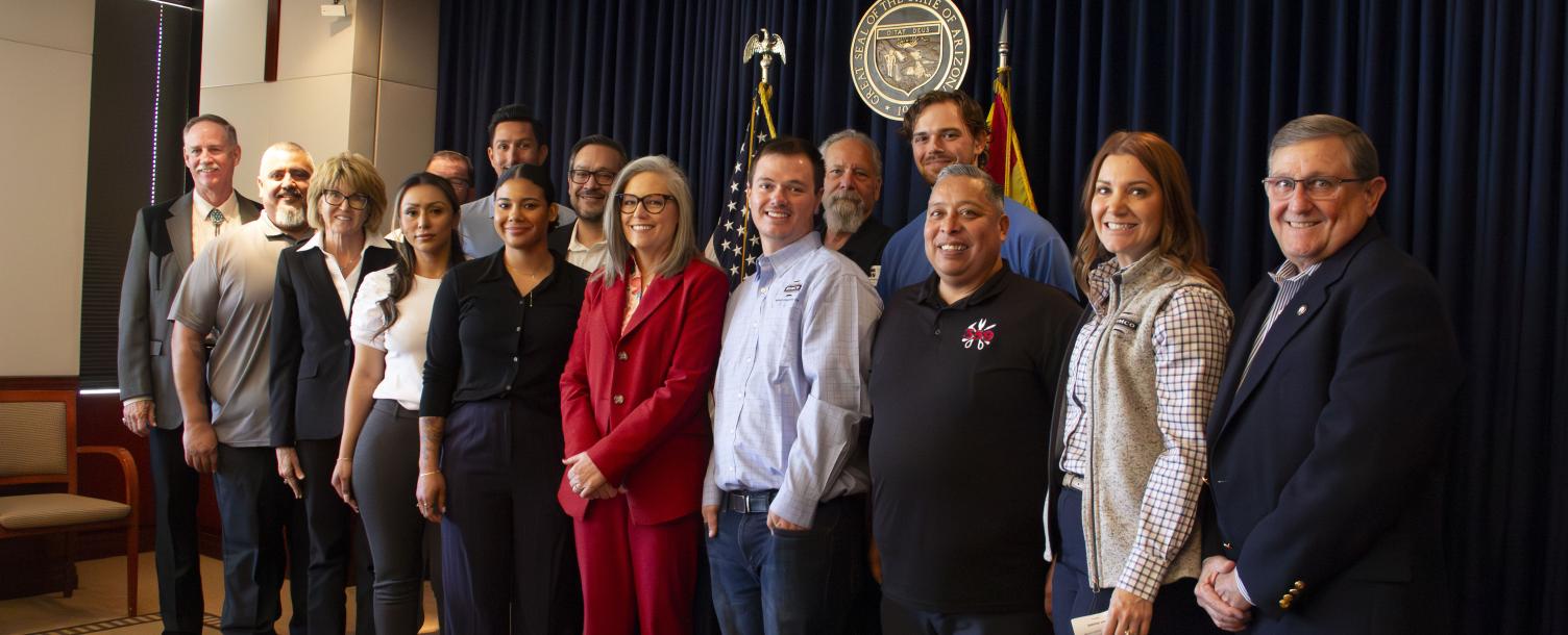 Governor Hobbs surrounded by apprentices.